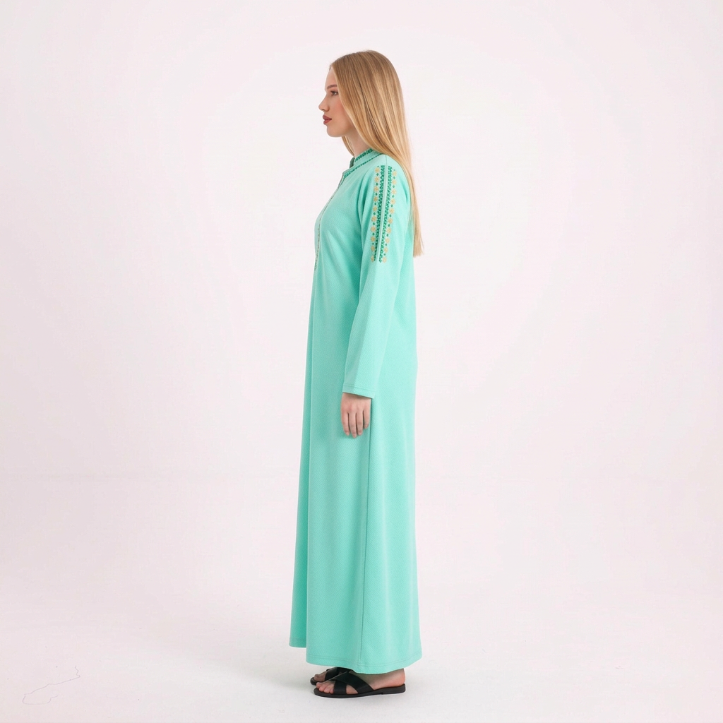 Side view of our blonde model in the bright mint abaya on a white background