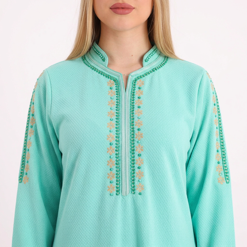 Close-up of the bright mint abaya’s neckline and decorative details